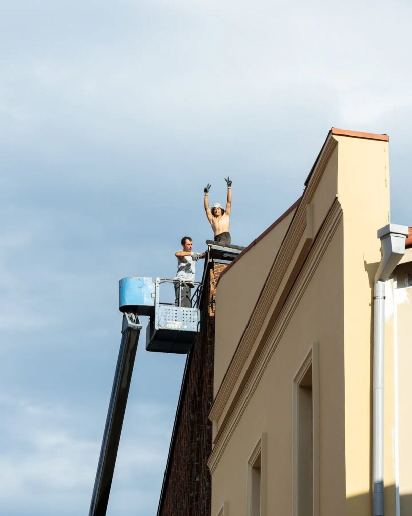 Georgia_ClydePhotography Painters at work atop a building in Georgia, posing for the camera